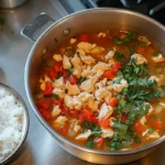 Close-up of chopt spicy chicken soup recipe with rice in a bowl.