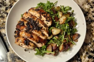 Close-up of black truffle chicken salad garnished with truffle slices